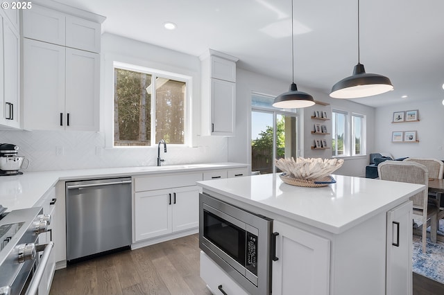 21773 SW Meadow Ter, Sherwood, OR 97140 - kitchen featuring appliances with stainless steel finishes, wood finished floors, tasteful backsplash, and recessed lighting