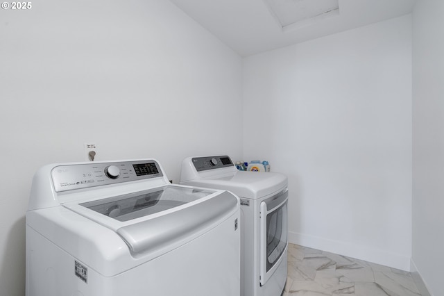 21773 SW Meadow Ter, Sherwood, OR 97140 - laundry area featuring washer and clothes dryer and light marble finish flooring