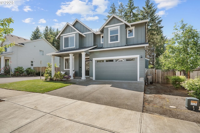 21773 SW Meadow Ter, Sherwood, OR 97140 - view of front facade with concrete driveway, board and batten siding, a garage, and a porch