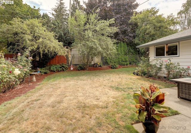 view of yard with an outdoor structure and fence