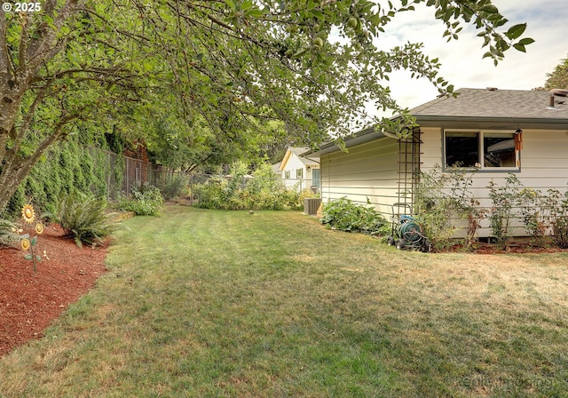 view of yard featuring central AC and a fenced backyard