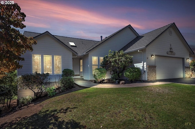 ranch-style home with a garage, driveway, roof with shingles, and a yard