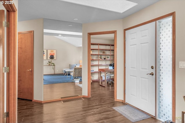 entryway featuring wood finished floors, visible vents, and baseboards