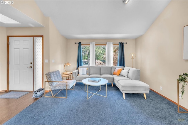 living area featuring baseboards and wood finished floors