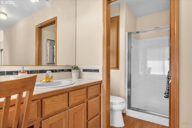 full bath featuring a shower stall, toilet, and vanity