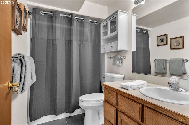 bathroom featuring toilet, tile patterned flooring, and vanity