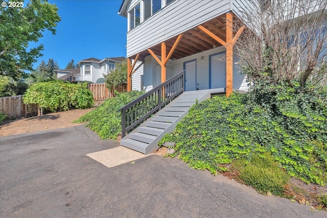 entrance to property featuring fence