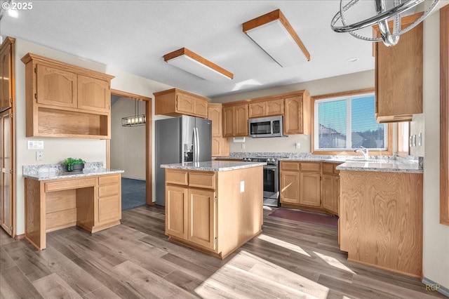 kitchen with open shelves, stainless steel appliances, a sink, a kitchen island, and wood finished floors