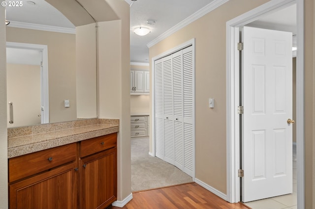 30406 SW Ruth St Unit 78, Wilsonville, OR 97070 - hall featuring light wood-style floors, ornamental molding, baseboards, and arched walkways