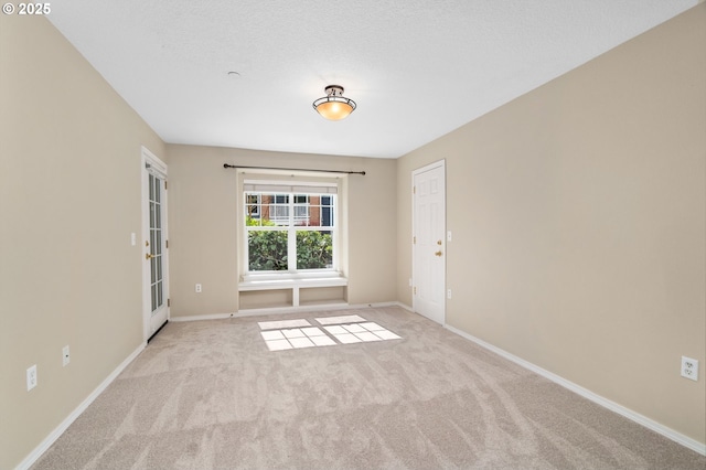 unfurnished room with carpet flooring and baseboards
