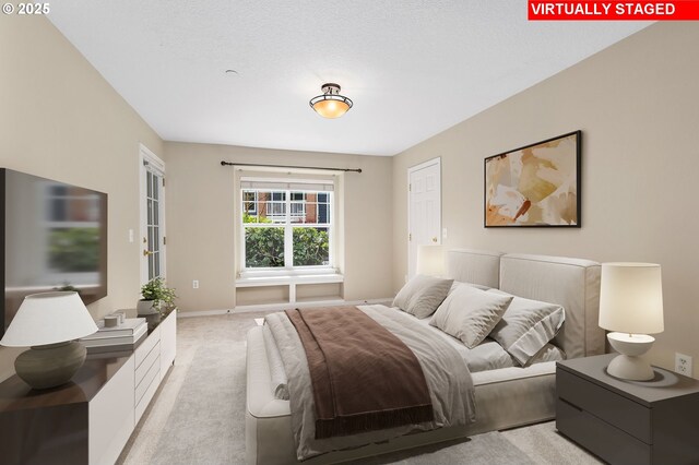 bedroom featuring baseboards and light carpet