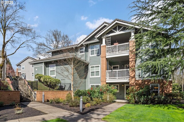 30406 SW Ruth St Unit 78, Wilsonville, OR 97070 - view of front of house with a balcony, stairs, and a front yard