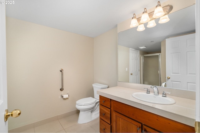 full bathroom featuring toilet, a stall shower, tile patterned flooring, baseboards, and vanity
