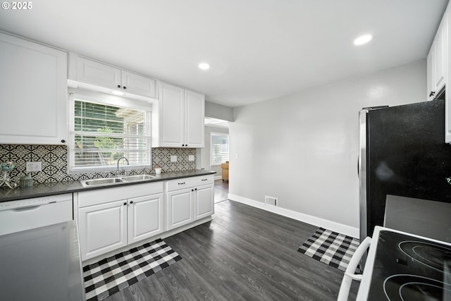 720 NW Johns Pl, Pendleton, OR 97801 - kitchen featuring freestanding refrigerator, range, white dishwasher, dark countertops, and white cabinets