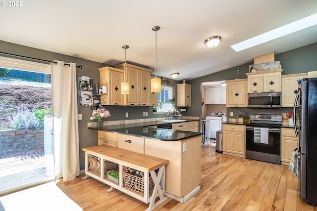 1950 Byron Creek Rd, Winston, OR 97496 - kitchen featuring stainless steel appliances, a peninsula, a skylight, a sink, and light wood finished floors