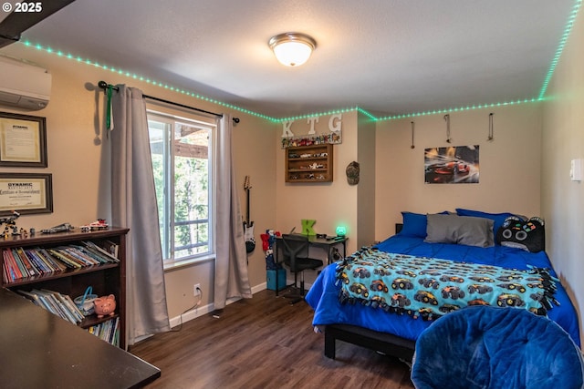 1950 Byron Creek Rd, Winston, OR 97496 - bedroom with wood finished floors, a wall mounted AC, and baseboards