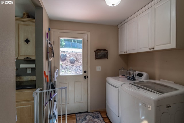 1950 Byron Creek Rd, Winston, OR 97496 - laundry room featuring cabinet space, washing machine and dryer, and light wood-type flooring