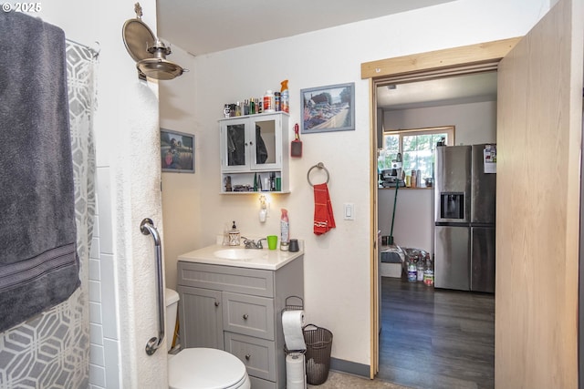 1950 Byron Creek Rd, Winston, OR 97496 - full bathroom with vanity, toilet, baseboards, curtained shower, and wood finished floors