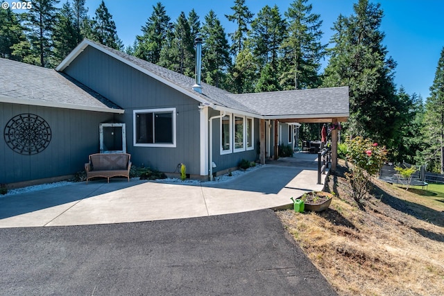 1950 Byron Creek Rd, Winston, OR 97496 - ranch-style house featuring a shingled roof, driveway, a carport, and a trampoline