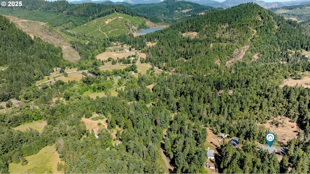 1950 Byron Creek Rd, Winston, OR 97496 - aerial overview of property's location featuring a mountainous background and a heavily wooded area