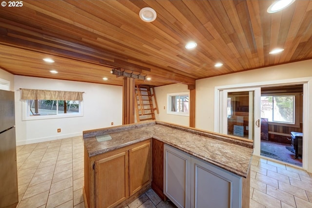 3162 Marine Dr, Astoria, OR 97103 - kitchen with wood ceiling, recessed lighting, plenty of natural light, freestanding refrigerator, and light stone countertops