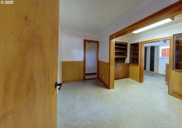 3162 Marine Dr, Astoria, OR 97103 - carpeted empty room with wainscoting, ornamental molding, and wooden walls
