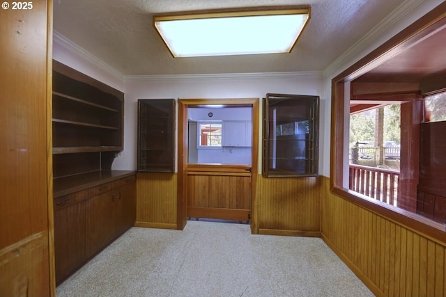 3162 Marine Dr, Astoria, OR 97103 - interior space with a wainscoted wall, plenty of natural light, light colored carpet, ornamental molding, and wood walls