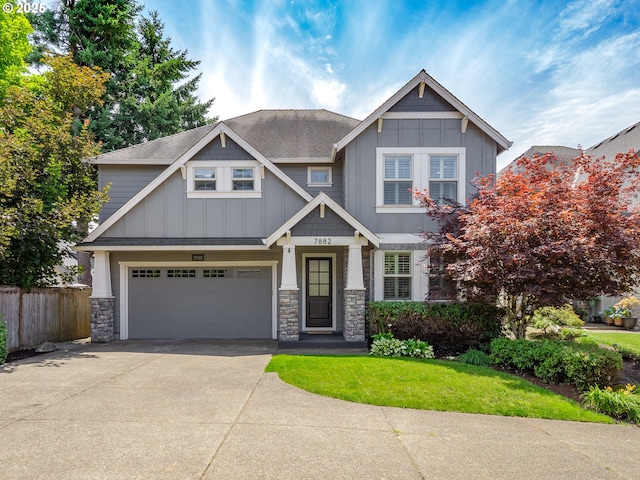 7882 SW Cinnabar, Wilsonville, OR 97070 - craftsman house featuring board and batten siding, concrete driveway, stone siding, a garage, and roof with shingles