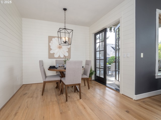 7882 SW Cinnabar, Wilsonville, OR 97070 - dining space with a chandelier, light wood finished floors, and wooden walls
