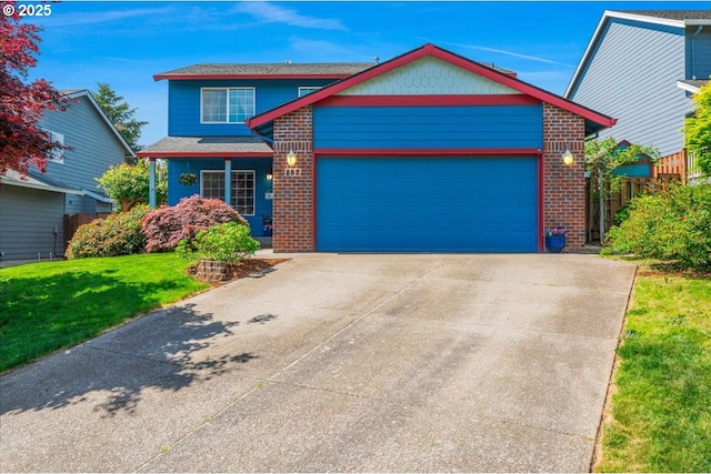 287 SW Oliver Ct, Dundee, OR 97115 - view of front of home featuring a garage, driveway, brick siding, and a front yard