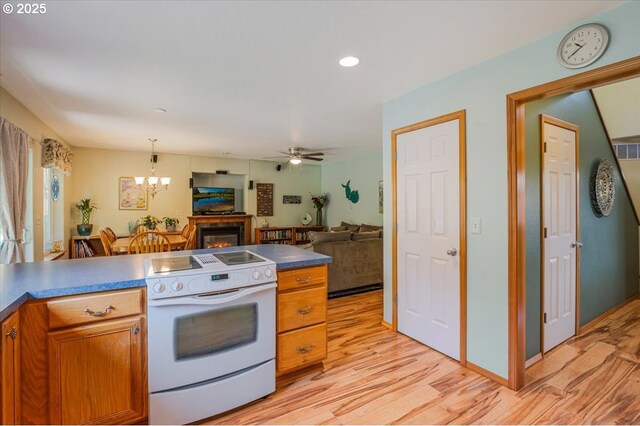 287 SW Oliver Ct, Dundee, OR 97115 - kitchen with white range with electric cooktop, light wood-type flooring, open floor plan, a chandelier, and recessed lighting