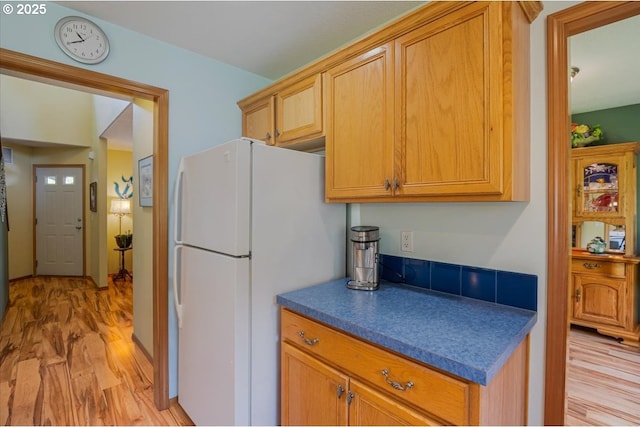 287 SW Oliver Ct, Dundee, OR 97115 - kitchen with freestanding refrigerator, light wood-type flooring, and dark countertops