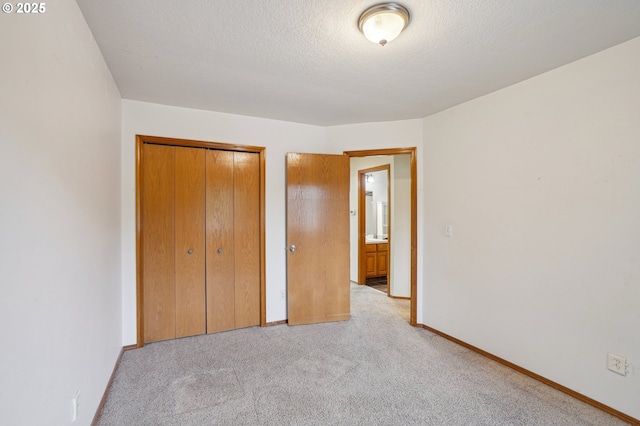 17701 Koch Ct, Sandy, OR 97055 - unfurnished bedroom featuring light carpet, a closet, baseboards, and a textured ceiling
