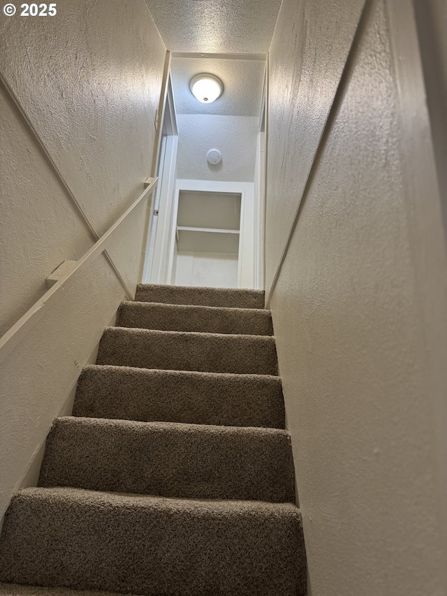 8305 SE Rhone St, Portland, OR 97266 - stairs featuring a textured wall and a textured ceiling