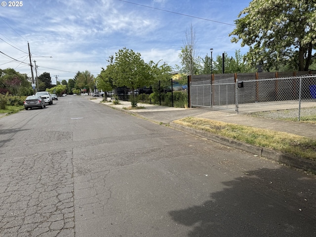 8305 SE Rhone St, Portland, OR 97266 - view of asphalt street with sidewalks and curbs