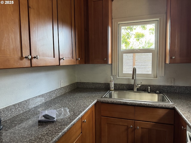8305 SE Rhone St, Portland, OR 97266 - kitchen featuring a sink, dark countertops, and brown cabinetry