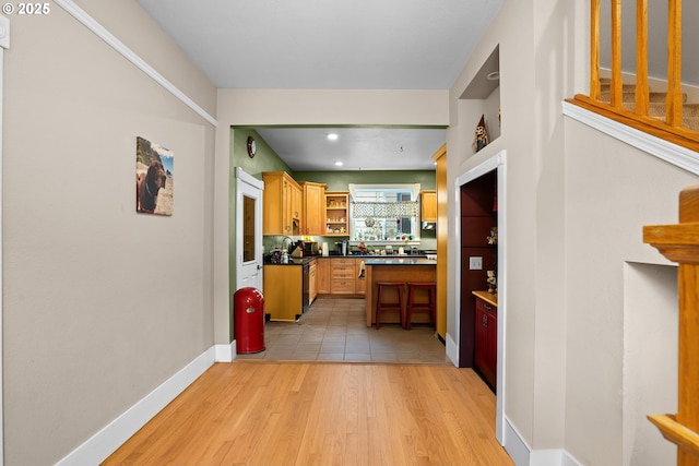 kitchen with a breakfast bar area and light wood-type flooring