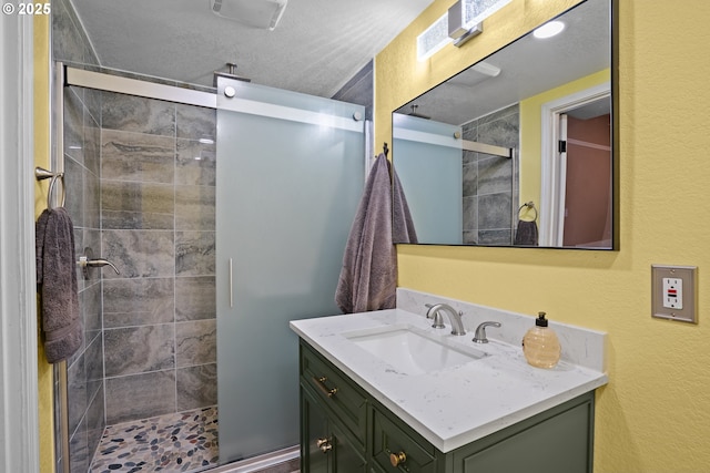 bathroom with a shower with door and vanity