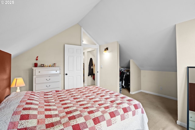 bedroom with light colored carpet, a closet, and vaulted ceiling