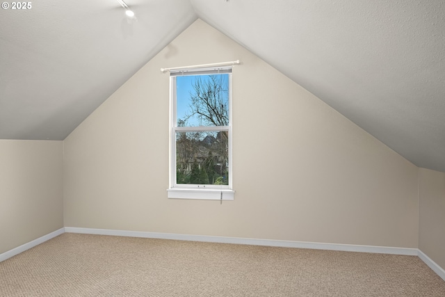 bonus room featuring carpet floors and vaulted ceiling