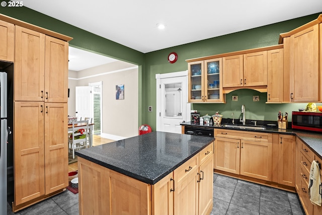 kitchen featuring sink, light brown cabinets, and a center island