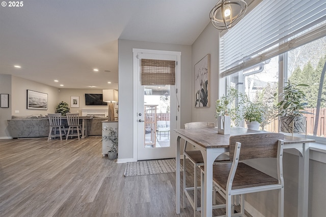dining room with recessed lighting, wood finished floors, and a wealth of natural light