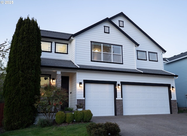 traditional-style house with a garage, stone siding, concrete driveway, and a shingled roof