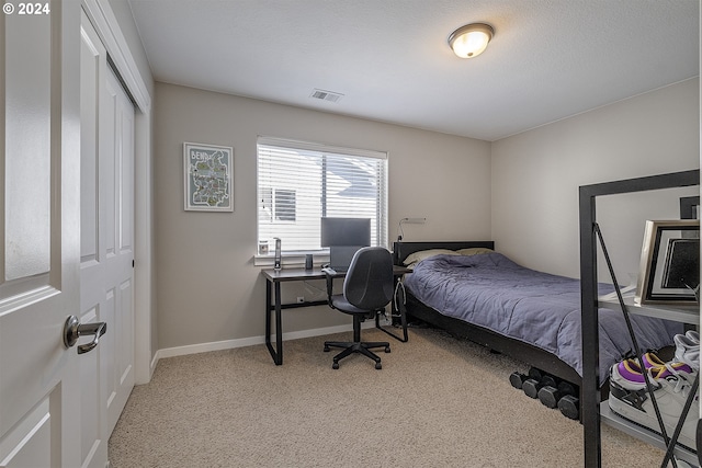 bedroom featuring a closet, carpet floors, visible vents, and baseboards