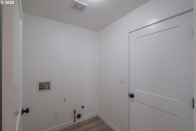 laundry room with washer hookup, light wood-type flooring, electric dryer hookup, and gas dryer hookup