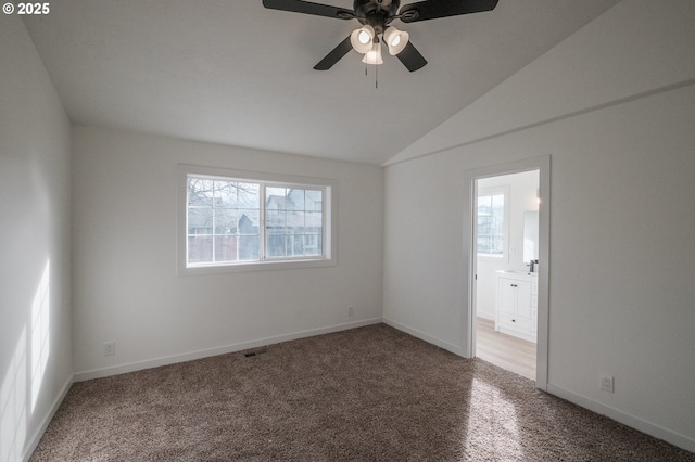 carpeted spare room with lofted ceiling and ceiling fan