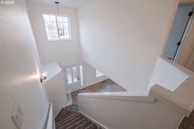 staircase featuring a high ceiling