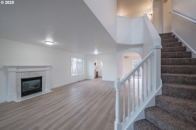 living room featuring a fireplace and light wood-type flooring