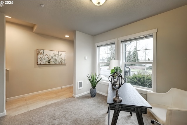 office space featuring baseboards, visible vents, light colored carpet, a textured ceiling, and recessed lighting