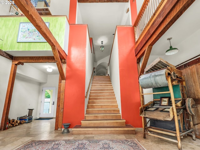 stairs featuring a high ceiling